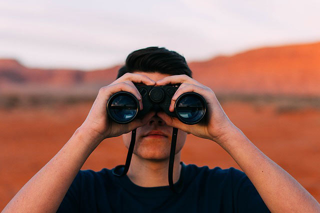 Man looking through binoculars